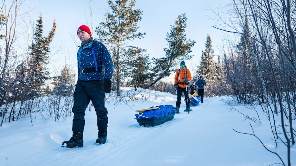 Hauling snow sleds to their camp site