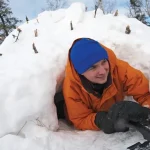 Scout emerging from his igloo