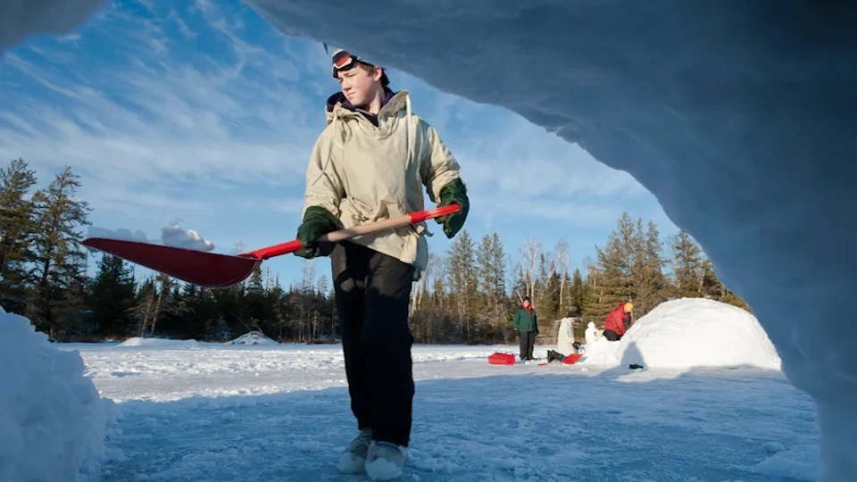 Scout building his snow cave